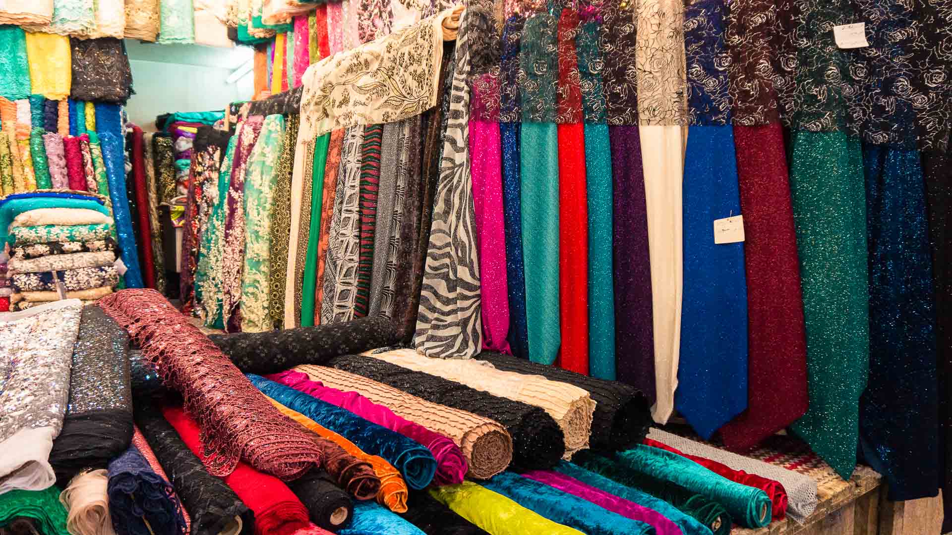 Nice fabric on a market in Iran. How expensive is Iran to Travel? Cost of travel in Iran.